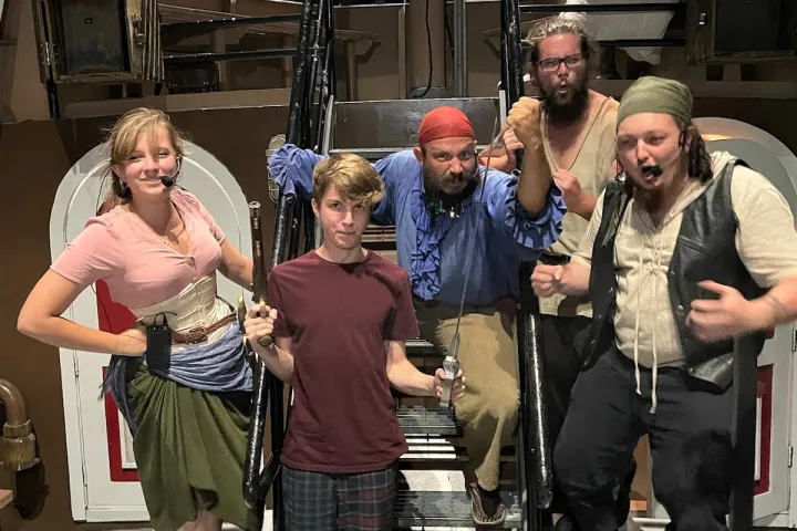 a group of people standing in front of a crowd posing for the camera