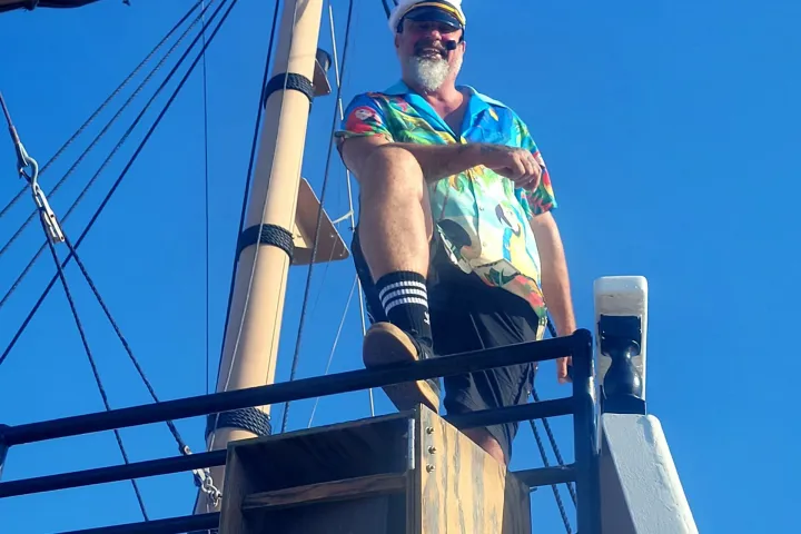 a person standing on top of a pole