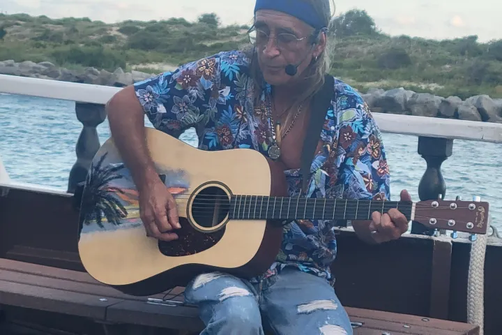 a man sitting on a boat in the water