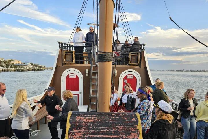 a group of people standing next to a body of water