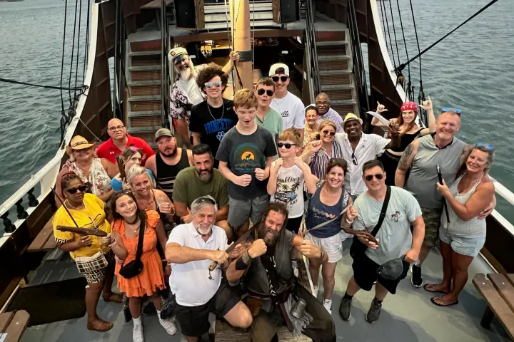 a group of people on a boat posing for the camera